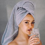 woman with glass of water after shower