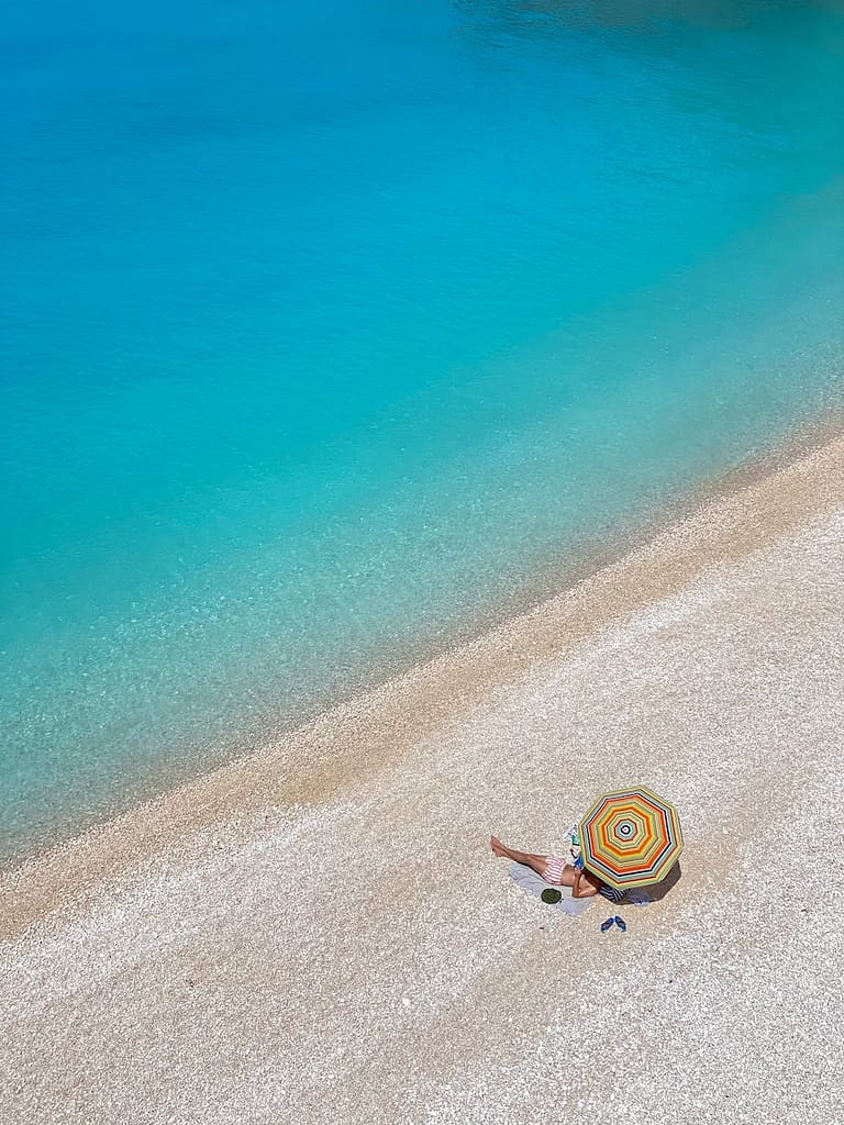 a person lying alone on an idyllic beach